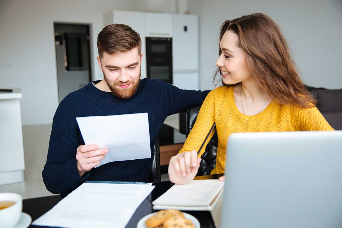 Happy young couple buying first home with Hess Mortgages